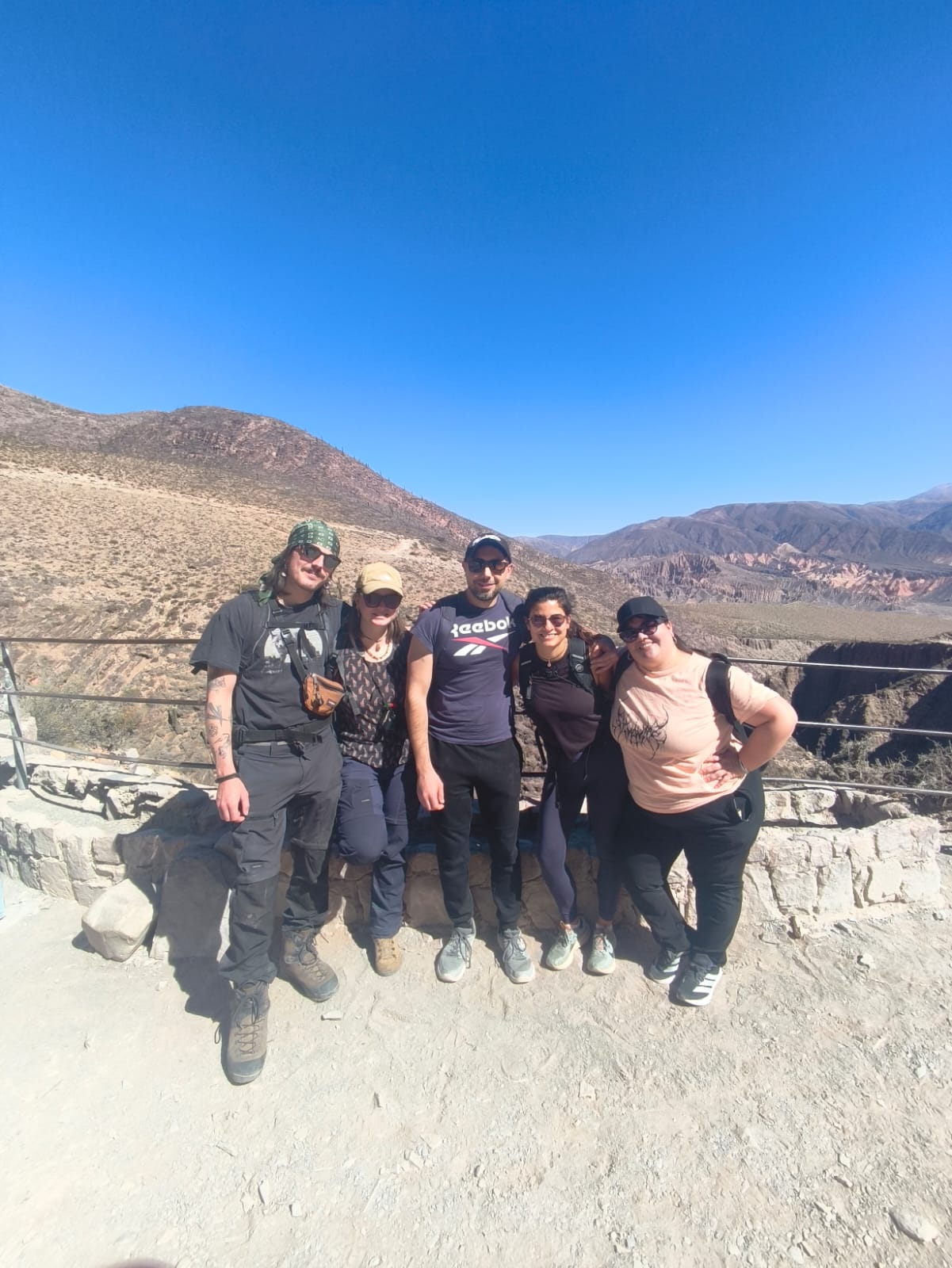 Dorien with the group she met at the hostel, posing together at a mountain viewpoint in the Quebrada de Humahuaca.